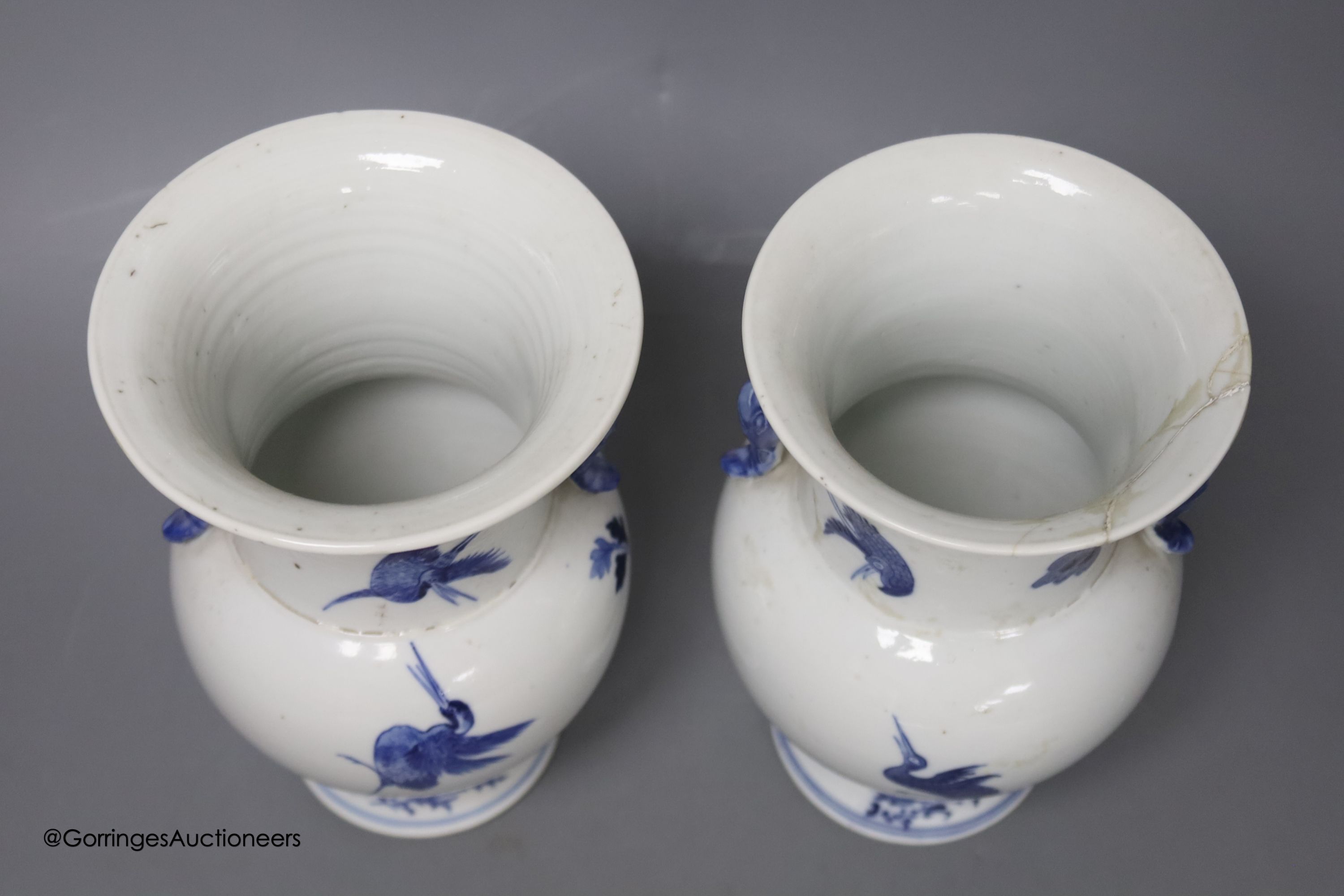A pair of Chinese blue and white 'phoenix' vases, Kangxi marks but late 19th century, height 20cm (a.f.)